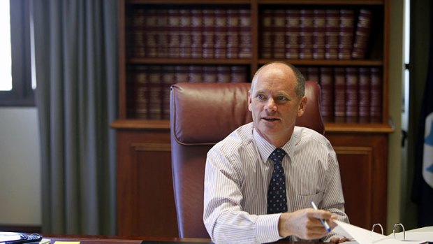 Queensland Premier Campbell Newman settles into his new desk.