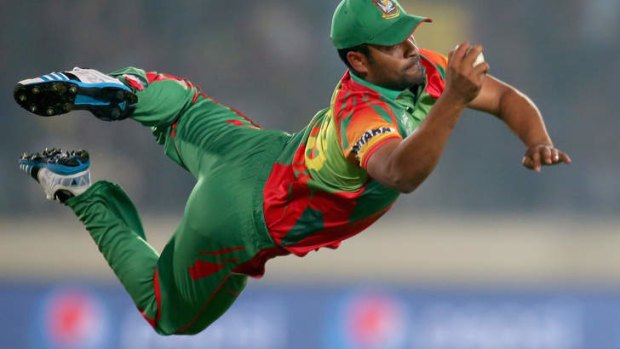 Tamim Iqbal of Bangladesh takes a diving catch to dismiss Dwayne Bravo of the West Indies.