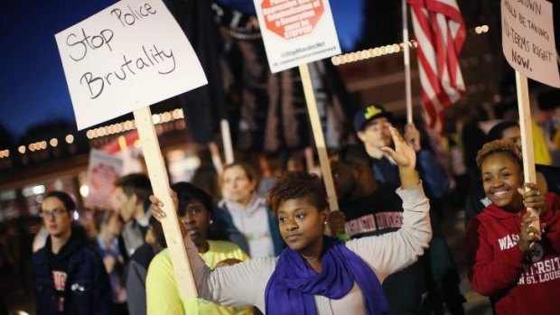 Demonstrators march toward the Ferguson Police Station as protests continue in the wake of 18-year-old Michael Brown's death.