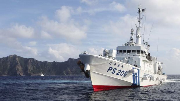 A Japanese Coastguard vessel sails past one of the disrupted East China Sea islands.