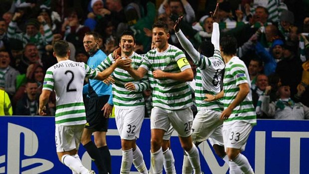 Ecstasy ... Celtic player's celebrate Tony Watt's goal which put them 2-0 up against Barcelona.