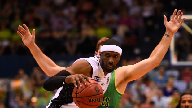 Hakim Warrick of Melbourne United looks to get past Mitch Norton of Townsville during the round eight match on Thursday.