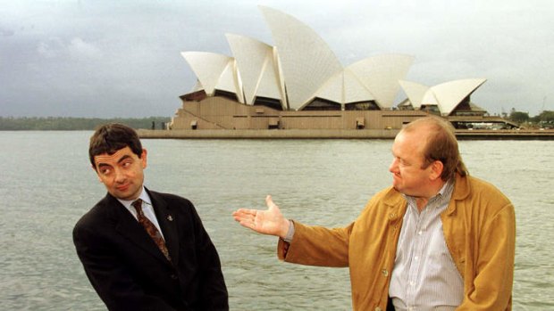 English comedian and actor Rowan Atkinson (L) and compatriot Mel Smith (R) pose for photographers with Sydney's famous landmark the Opera House.