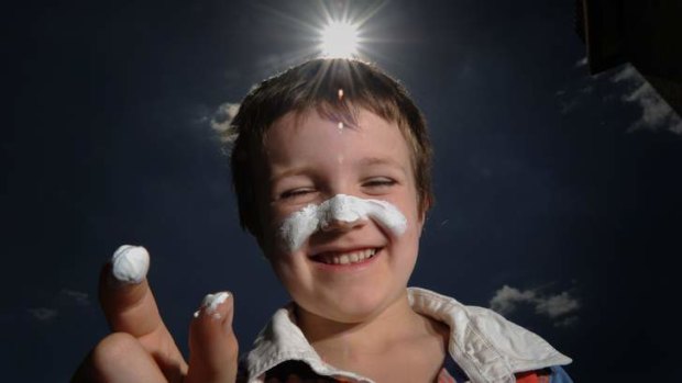 FACING FACTS: Joe O'Daly, 7, applies a thick smear of zinc cream which though unpleasant is the most effective block to damaging ultraviolet light.