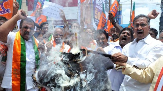 Activists of the Bharatiya Janatha Party (BJP) burn an effigy of Union Home Minister P. Chidambaram.