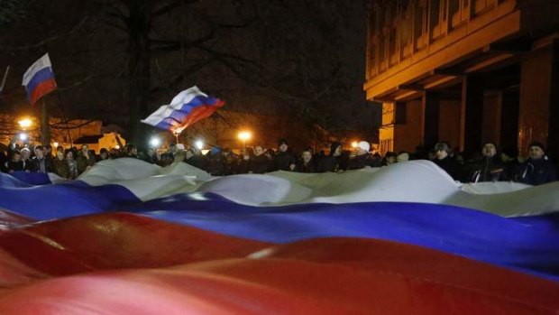 People carry a giant Russian flag during a pro-Russian rally in Simferopol.