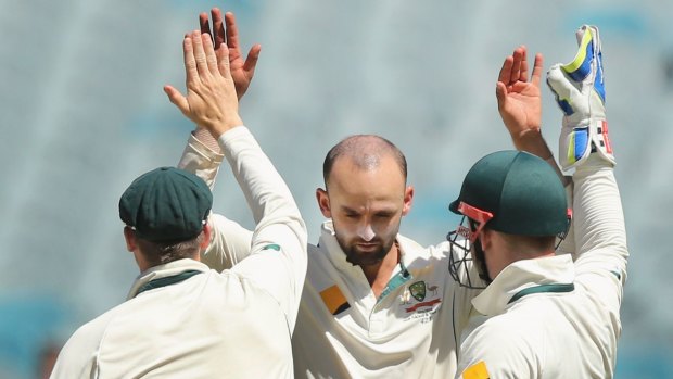 MELBOURNE, AUSTRALIA - DECEMBER 29: Nathan Lyon of Australia celebrates a wicket with Steve Smith (L) and Peter Nevill during day four of the Second Test match between Australia and the West Indies at Melbourne Cricket Ground on December 29, 2015 in Melbourne, Australia.  (Photo by Michael Dodge/Getty Images)