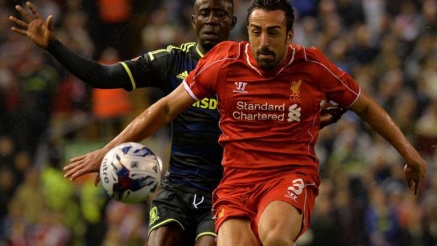 Eyes on the ball: Liverpool's Jose Enrique (right) vies with Middlesbrough midfielder Albert Adomah.
