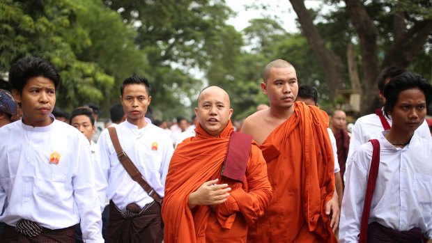 Myanmar's top Buddhist body has moved against nationalist Buddhist monk Wirathu, center.