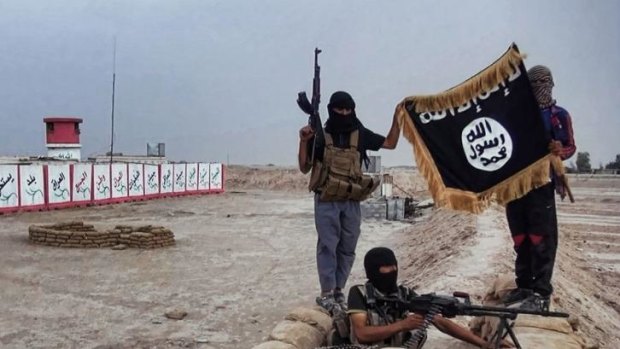 Symbols: Militants of the Islamic State of Iraq and the Levant (ISIL) posing with the trademark Jihadists flag.