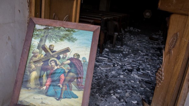 An image of Jesus Christ is seen placed at a destroyed church in the newly liberated town of Bartella in Gogjali, Iraq. 