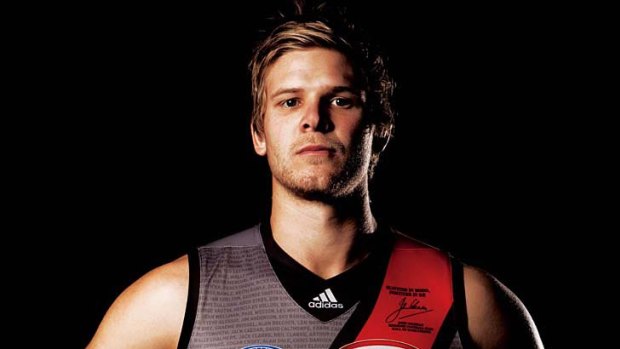 Going grey ... Essendon's new alternate strip and (inset) the original alternate jumper with a wider red sash.