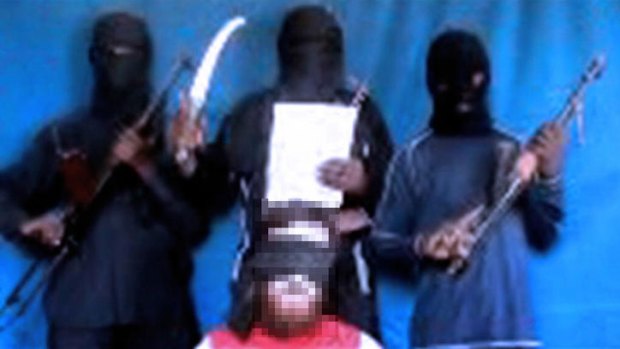A video image of al-Qaeda linked terrorists with hostage Chris McManus.