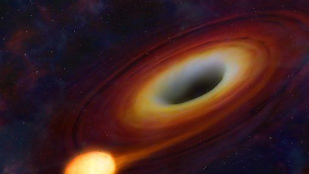 This artist's image provided by the University of Warwick shows a star being distorted by its close passage to a supermassive black hole at the centre of a galaxy.