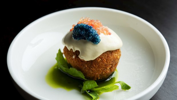 Spanner-crab rice ball with scampi caviar, finger lime, sate oil and oyster emulsion.