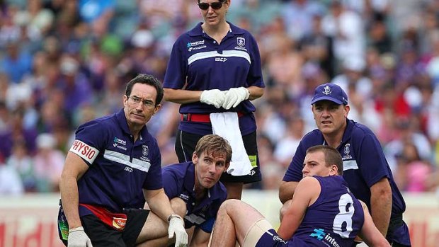 An all too familiar sight for Dockers fans in 2011 - Nick Suban having a broken leg attended to by trainers. Freo lost more than 100 games more to injury than the average club last year, according to a report released today.