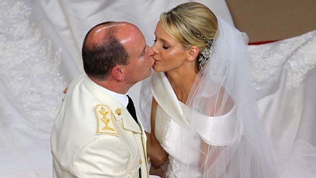 Prince Albert II kisses Princess Charlene of Monaco during their religious wedding, but they reportedly slept at separate hotels on their honeymoon.