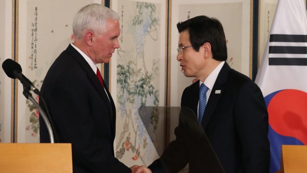 US Vice President Mike Pence, left, shakes hands with Hwang Kyo-ahn, South Korea's acting president.