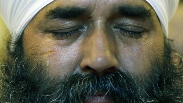 Tragedy ... a tear runs down the cheek of a member of the Sikh Temple of Wisconsin.