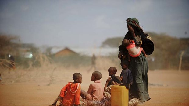 Sarura Ali and her six children wait outside a food distribution point in the Dadaab refugee camp in north-eastern Kenya.