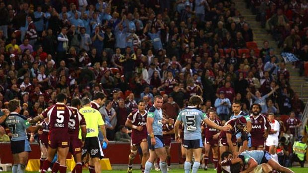 A brawl erupts as Steve Price is seen on the ground unconcious during the final game of last year's State of Origin series.