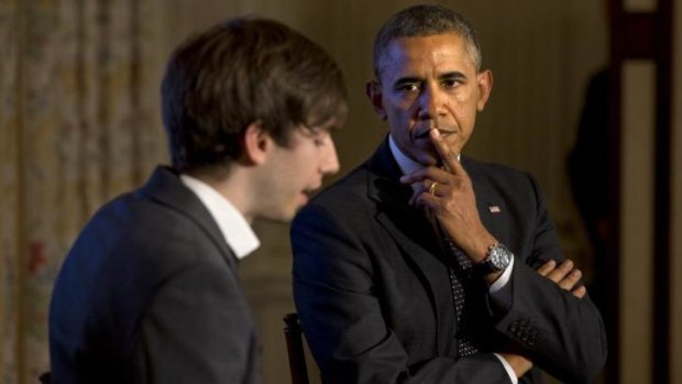 Barack Obama listens to a question submitted on Tumbr, read by the social media company's CEO David Karp.