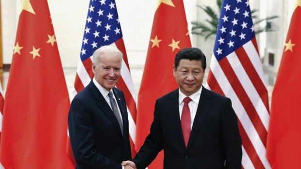 Chinese President Xi Jinping shakes hands with U.S. Vice President Joe Biden inside the Great Hall of the People in Beijing.