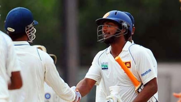 Sri Lankan captain Kumar Sangakkara (right) and Indian captain Mahendra Singh Dhoni shake hands after the second Test ended in a draw.