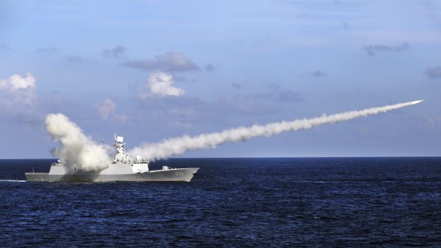  A Chinese frigate launches an anti-ship missile during military exercises in the South China Sea. Country's strategy is aimed partly at keeping the US at bay. 