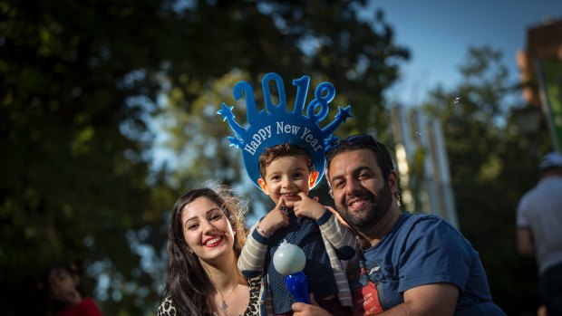 31/12/17 Ola and Fadi Sarawan with their son Adam (3) celebrate New Years Eve 2017 at the family night in Yarra Park, Melbourne. Photograph by Chris Hopkins
