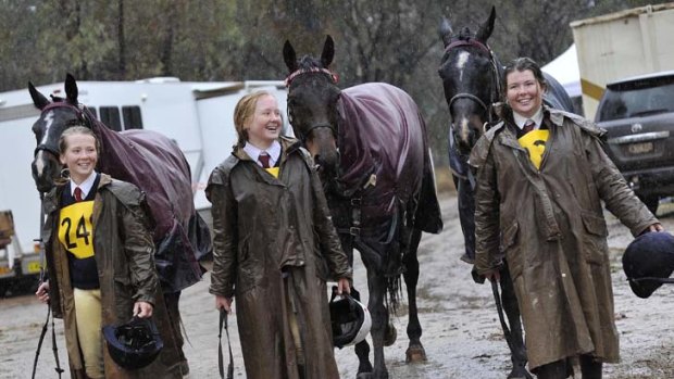 Taking it in their stride ... braving the rain were North West Equestrian Expo competitors Annabelle, 12, Emily, 14, and Katelyn Turnbull, 16, from Tamworth.