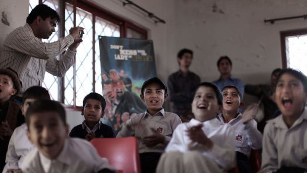 Pakistani orphans reacts while watching an early screening of the first episode of the animates Burka Avenger series, at an orphanage on the outskirts of Islamabad, Pakistan.