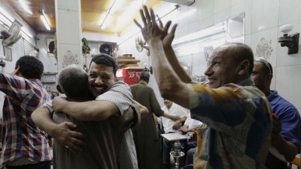 Egyptians celebrate at a tea house in Cairo.
