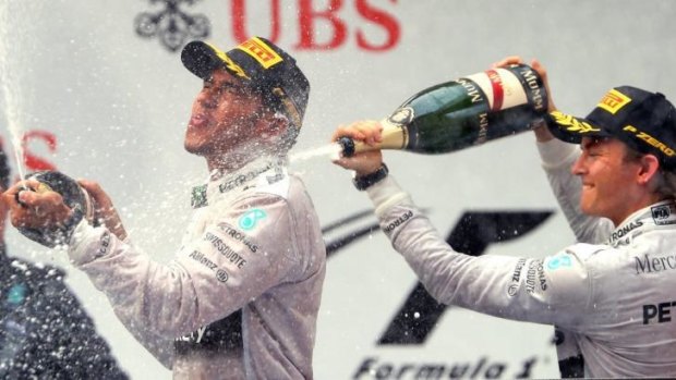 Friends and rivals: Lewis Hamilton and Nico Rosberg celebrate first and second at the Chinese Grand Prix.