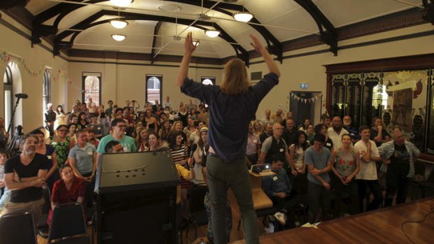 No dogma: Comedian Sanderson Jones, founder of the Sunday Assembly, leads the gathering of atheists at Redfern Town Hall.