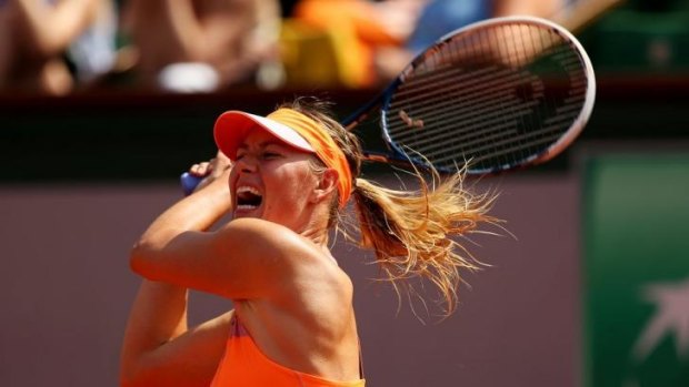 Maria Sharapova returns a backhand to Simona Halep during her French Open final win.
