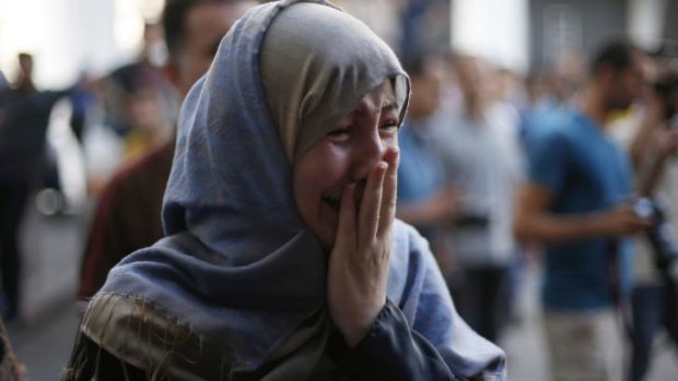 A Palestinian mourns at a hospital in Gaza City after an Israeli strike on a packed market. 
