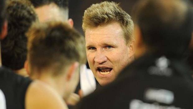 Collingwood's coach Nathan Buckley urges his players on at quarter-time.