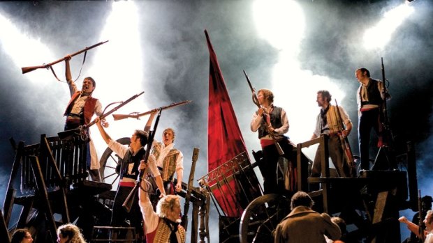 Hear them sing: The cast of <i>Les Miserables</i> man the barricades.