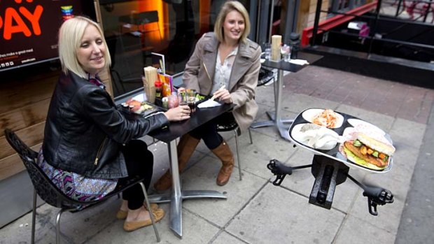 Flying sushi: The "iTray" brings food to customers at a YO! Sushi restaurant in London.