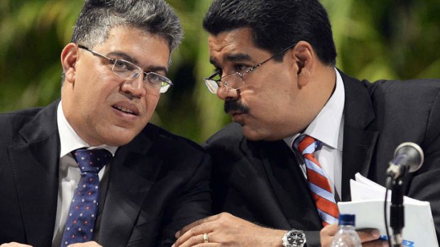 Venezuelan President Nicolas Maduro (right) talks with Foreign Minister Elias Jaua at a meeting in Caracas on Tuesday.