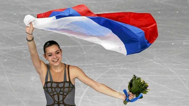 Controversy: Russia's Adelina Sotnikova celebrates holding her flag at the end of the Figure Skating Women's free skating Program.