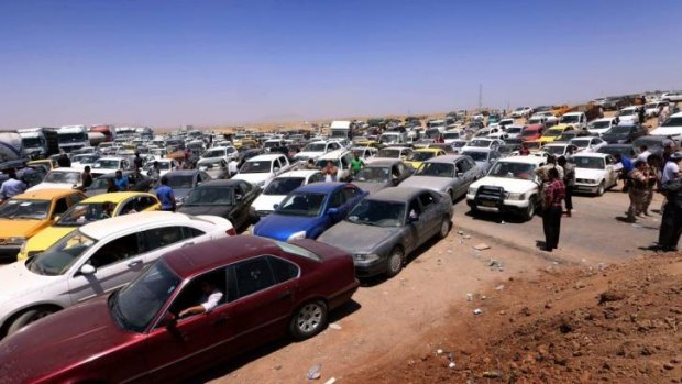 Mass exodus ... Iraqis fleeing violence in the Nineveh province wait in their vehicles at a Kurdish checkpoint in Aski kalak, the capital of the autonomous Kurdish region of northern Iraq.