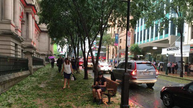 CBD workers begin to venture out onto George Street after the storm.