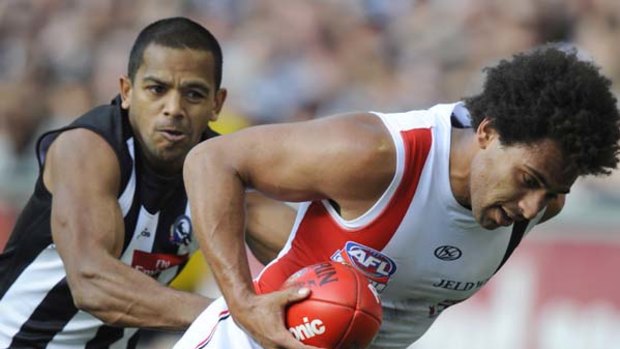 Collingwood's Leon Davis tries to run down James Gwilt at the MCG last Saturday.