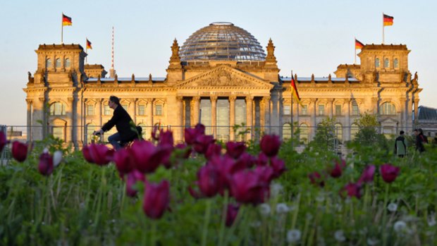 Bloc party ... a rider passes the Reichstag building, Germany's lower house of parliament.