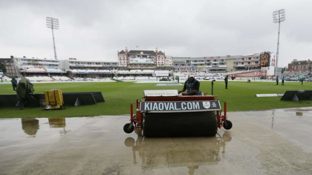 Fighting a losing battle: Ground staff work to clear the standing water.