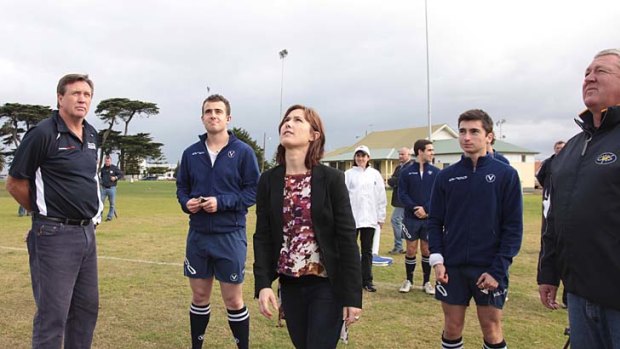 Bill Deller (left) watches Chelsea Roffey (right) toss the coin in the name of a fair go for umpires.