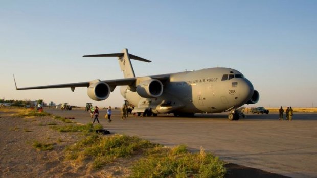 Moral support: An Australian C-17 Globemaster unloads its cargo of ammunition at Erbil airport in Iraq.