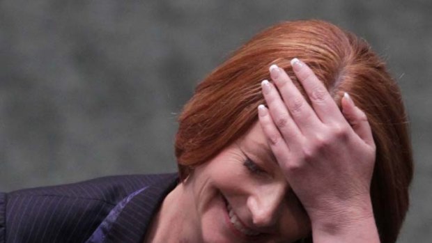 Julia Gillard enjoys a lighter moment during a fiery question time, in which she hit back at Opposition attacks on embattled Labor MP Craig Thomson.
